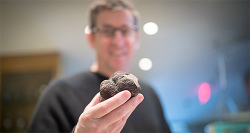 Chef Ken Frank holding a truffle
