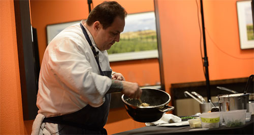 Rick Tramonto stirs risotto during his cooking demo